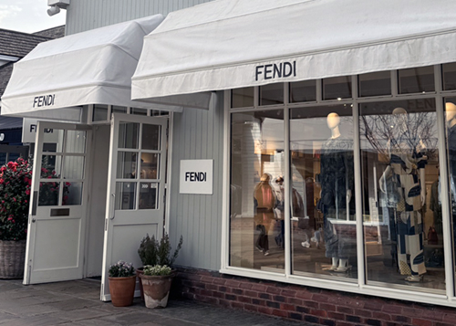 Fendi storefront with display windows and white facade.